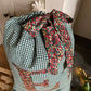 Personalised green linen Christmas sack with Liberty monogram and printed sash tie - close up detail