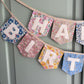 Close up of Liberty London Floral Print Bunting with ivory felt happy birthday applique letters