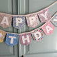Close up of Liberty London Floral Print Bunting with ivory felt happy birthday applique letters