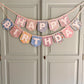 Liberty London Floral Print Bunting with ivory felt happy birthday applique letters hung on wardrobe