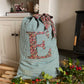 green gingham linen Christmas sack with Liberty print monogram - personalised gift bag in lifestyle setting