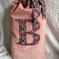Personalised red linen Christmas sack with Liberty monogram and printed sash tie - close up detail