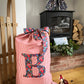 Red striped linen Christmas sack with Liberty print monogram - personalised gift bag in lifestyle setting