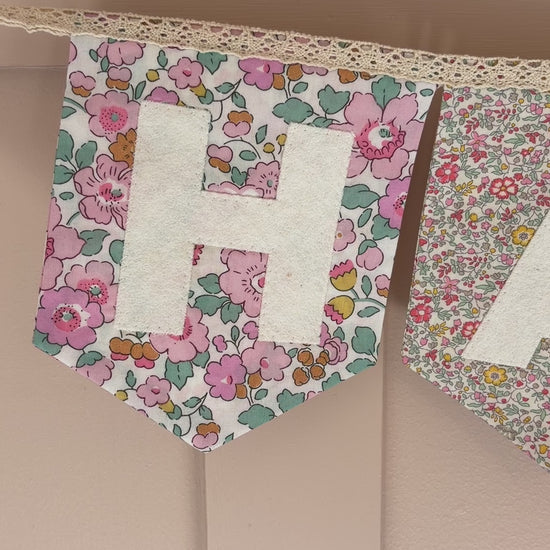 Video of continuously strung Happy birthday bunting in floral Liberty London prints