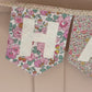 Video of continuously strung Happy birthday bunting in floral Liberty London prints