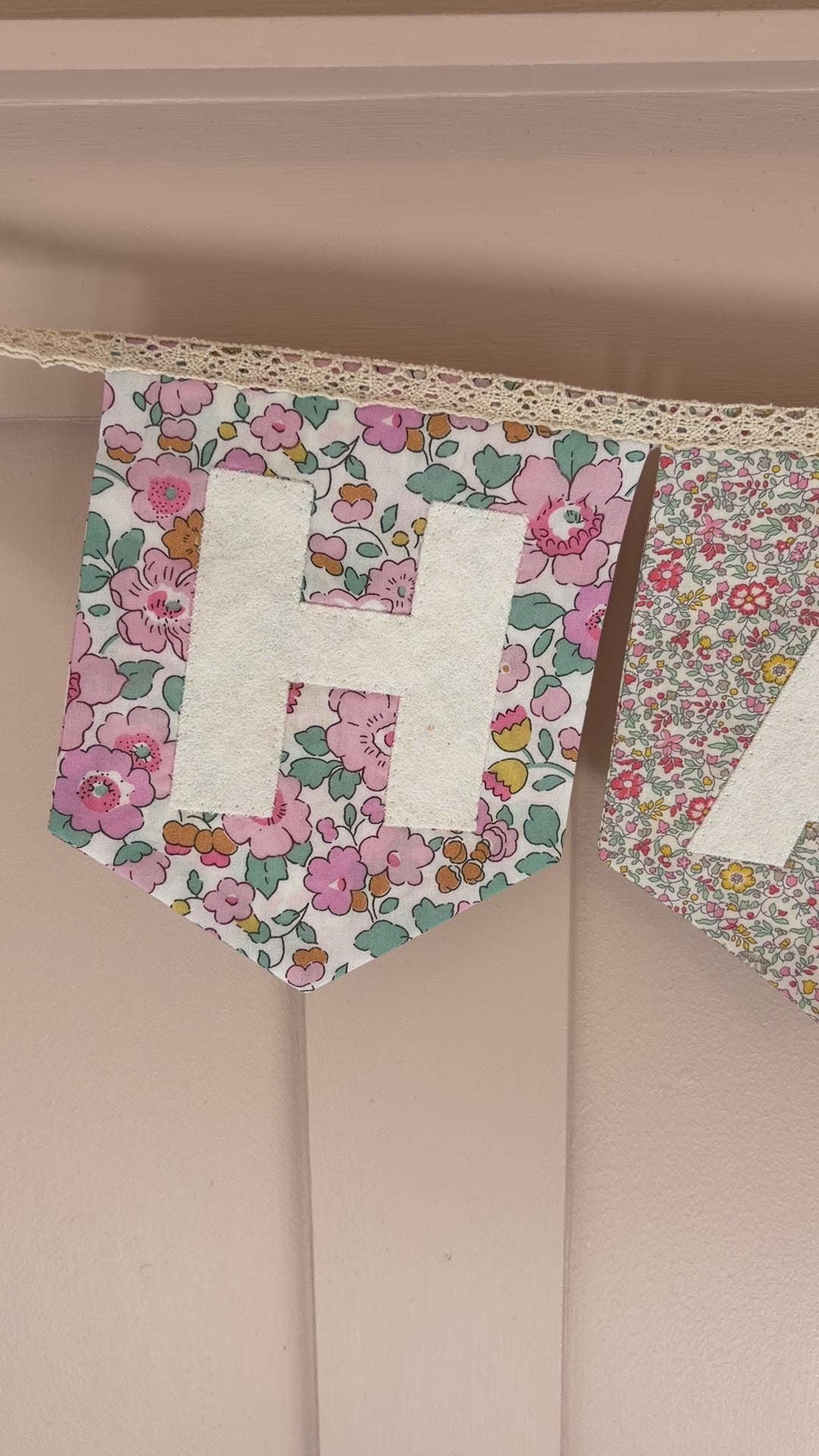 Video of continuously strung Happy birthday bunting in floral Liberty London prints